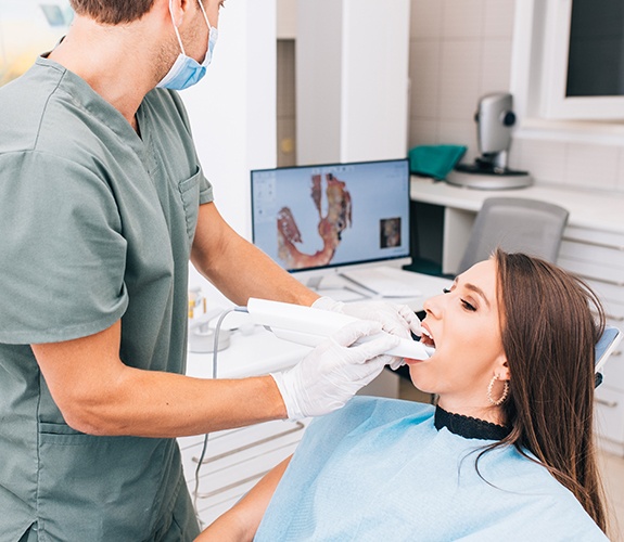Dentist using intraoral camera to capture images of a patient's smile