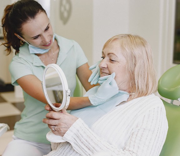 Older woman learning how dentures are made in Lake Zurich