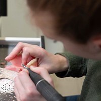 Lab technician creating a set of dentures