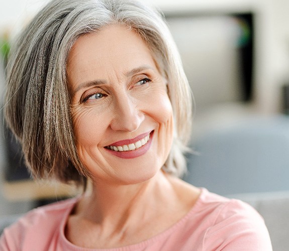 Older woman smiling after completing dental implant post-op instructions in Lake Zurich