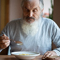 Man eating a bowl of soup