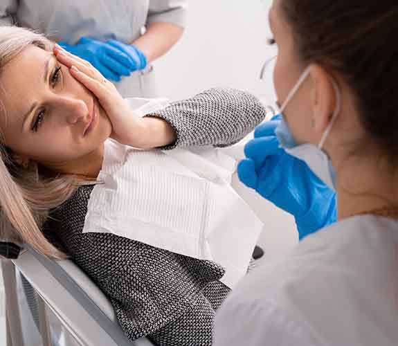 Woman with tooth pain at the dentist’s office