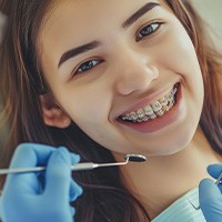 Dentist holding mouth mold with braces