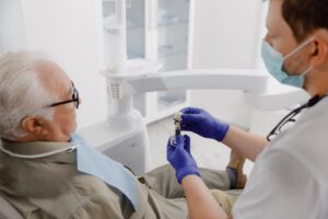a patient speaking with their dentist about dental implants