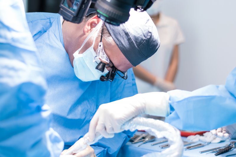 doctors performing dental implant surgery