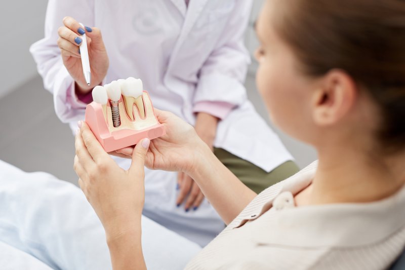 dentist explaining success rate of dental implants to patient 